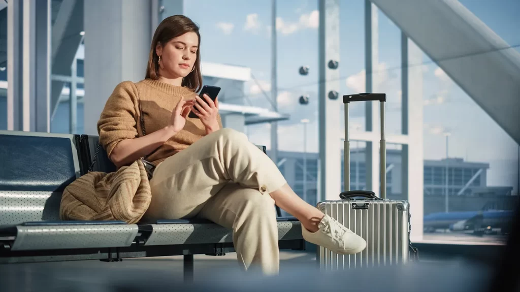 airport-terminal-woman-waits-flight-uses